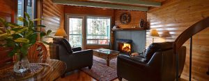 view from cozy living room to private hot tub deck at Jacob's Creek Cabin 12 at point no point resort on vancouver island